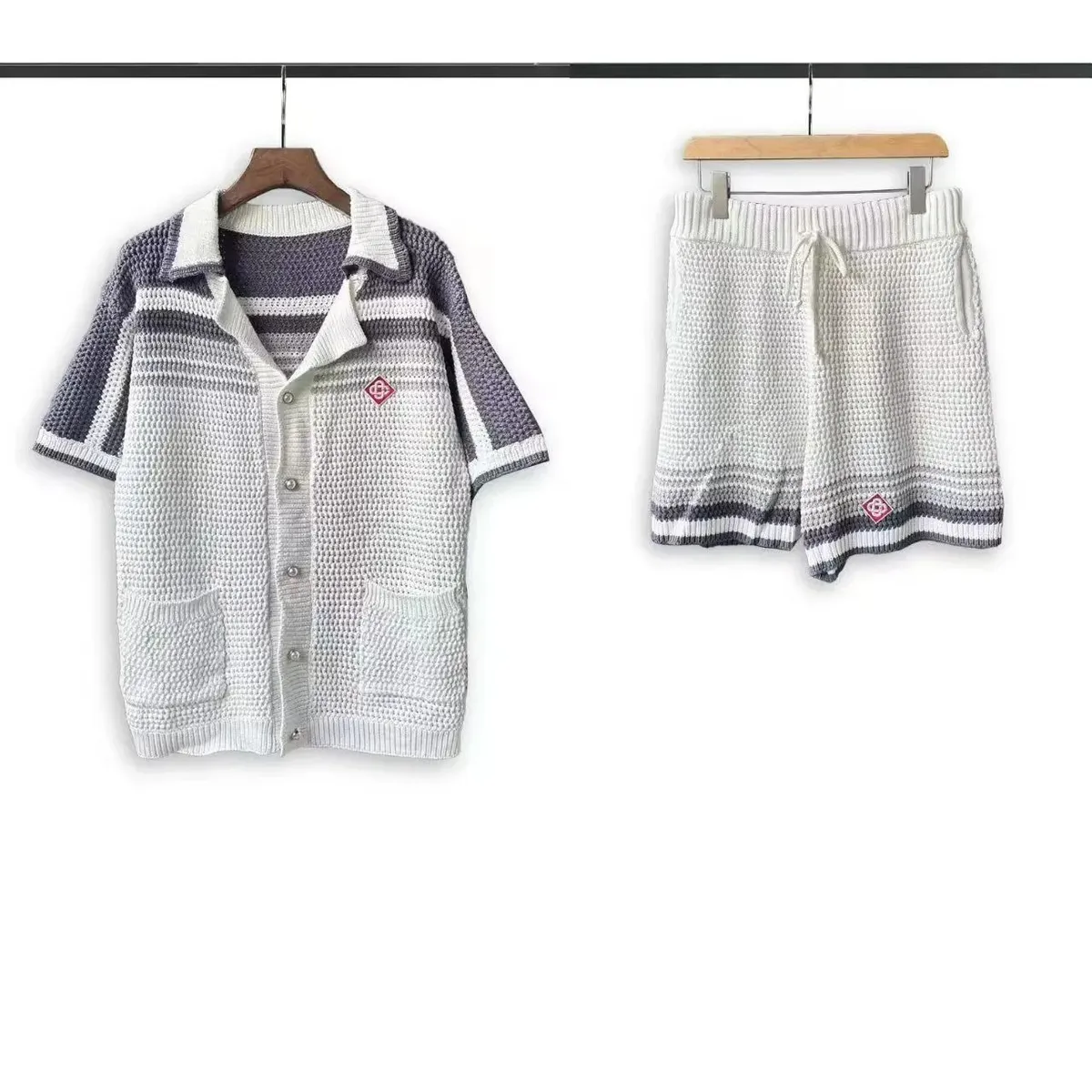 Casablanca green and white crochet knit polo and shorts set hanging on white background.