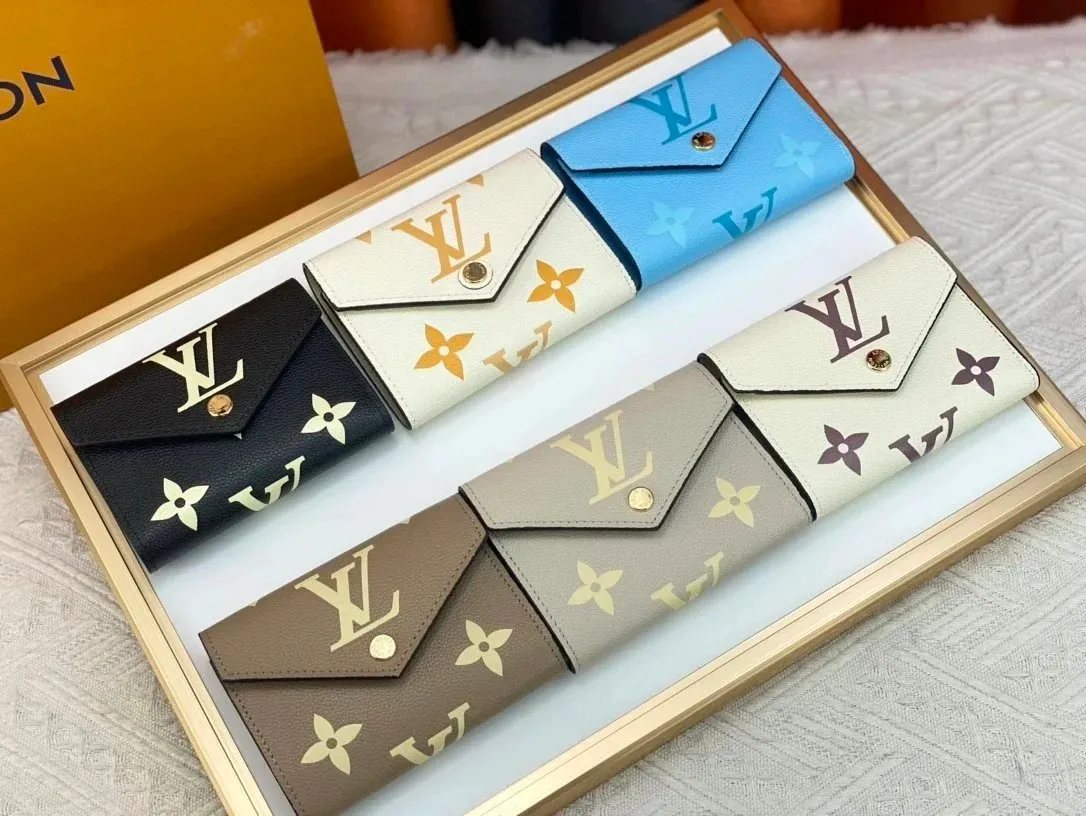 Louis Vuitton monogram pattern envelope wallet with a slim flap and snap closure.