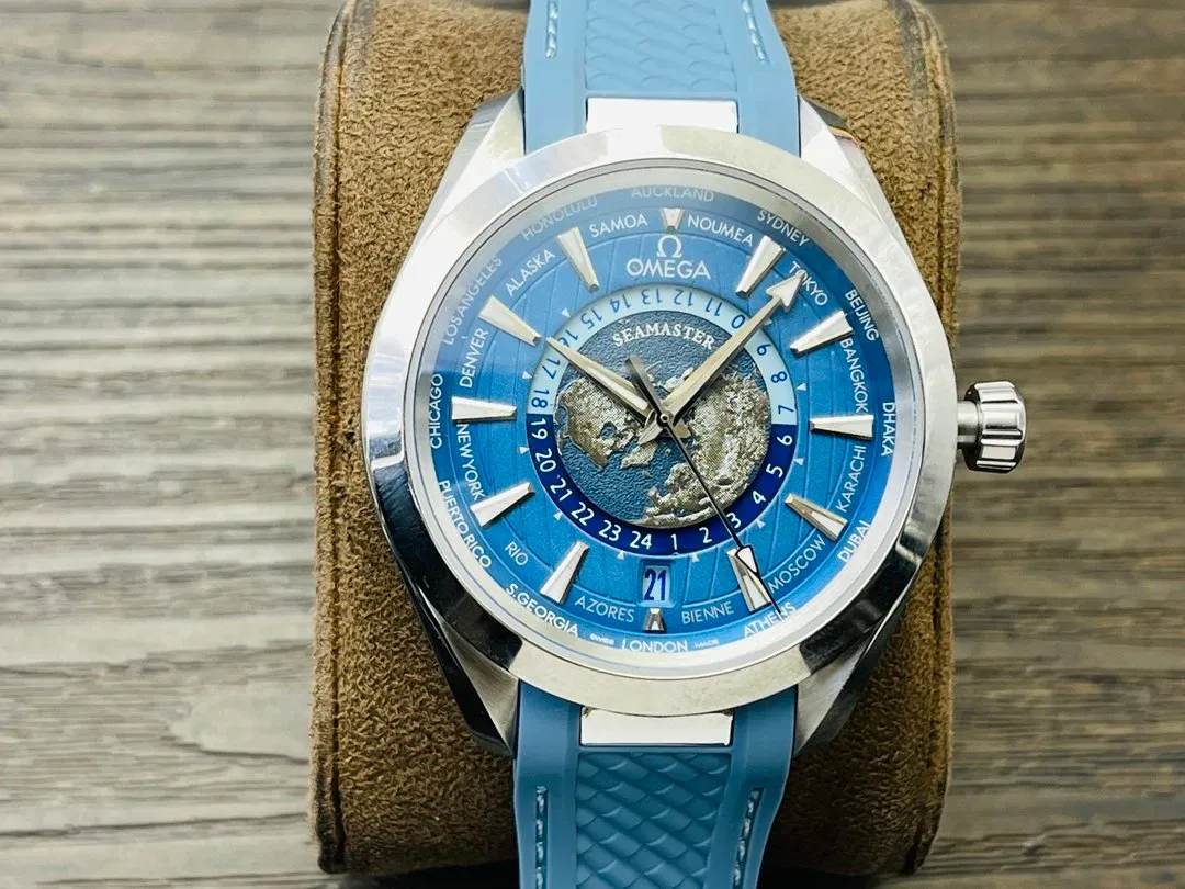 Omega Seamaster watch with blue dial, world-time city ring, and blue strap.