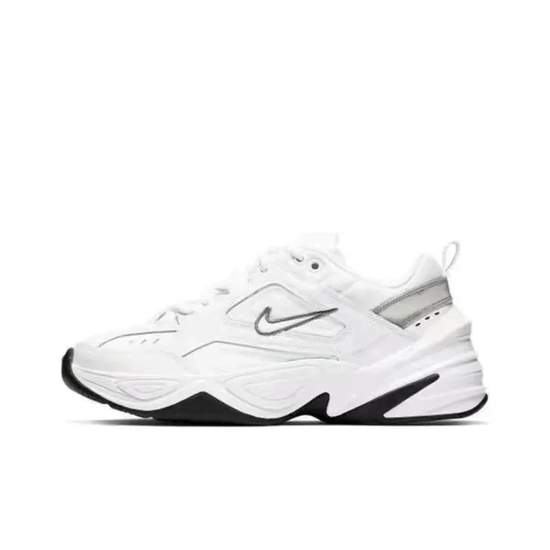 Nike white sneakers with a black sole, low-top profile, and swoosh logo on a white background.