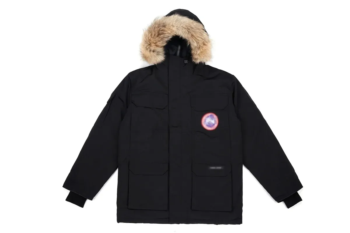 Black Canada Goose hooded parka with faux-fur trim, chest patch, and four flap pockets.