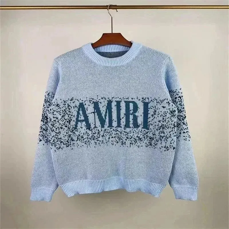 AMIRI knit sweater in light blue with a large front graphic and ribbed trim.
