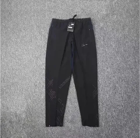 Nike black athletic pants with graphic pattern