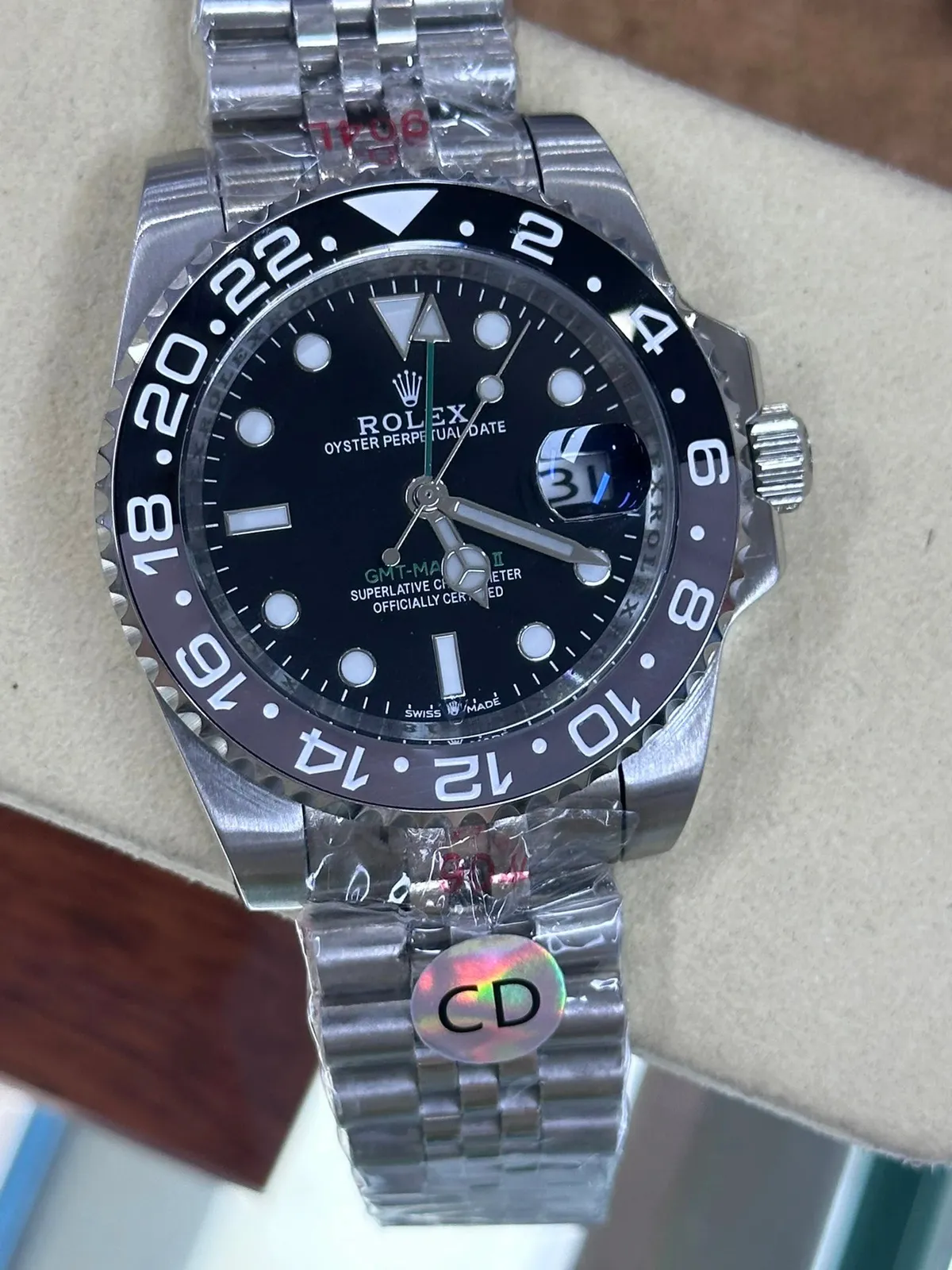 Rolex GMT-Master II watch with black dial, steel bracelet, and rotating bezel.