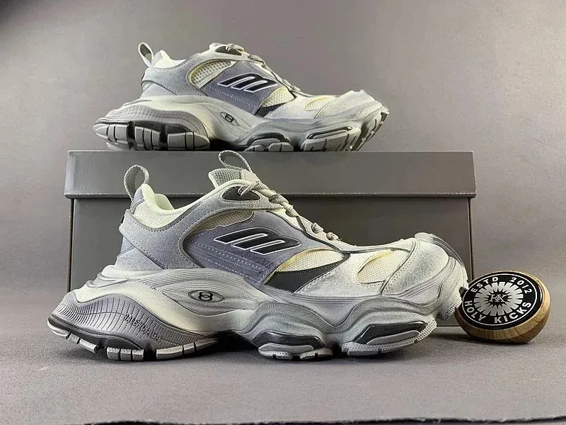 Balenciaga gray mesh and suede chunky sneakers shown in side view with a thick sole.