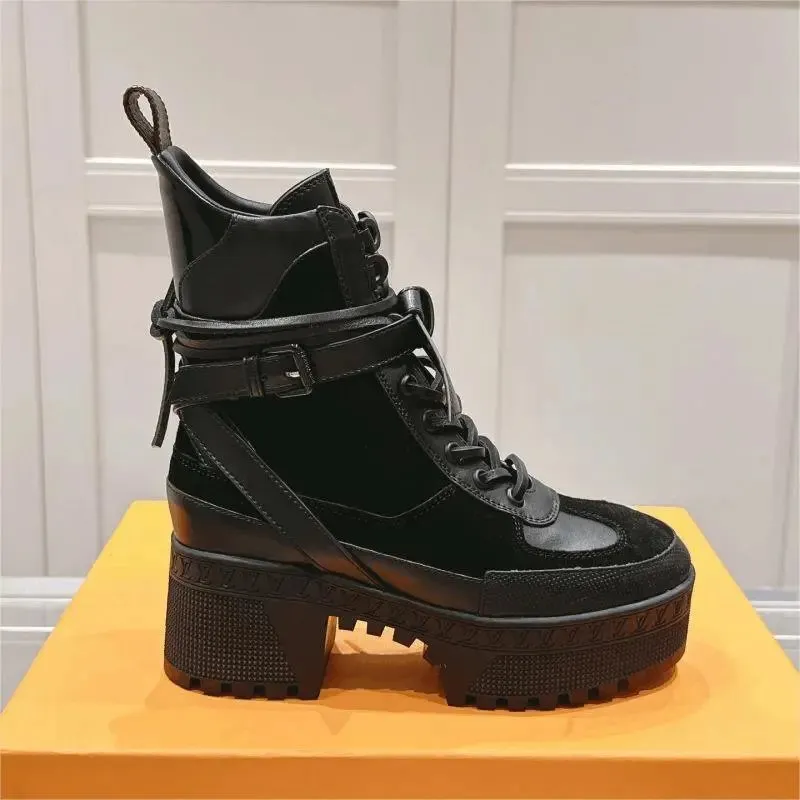 Black Louis Vuitton platform ankle boot with lace-up front and lugged sole.