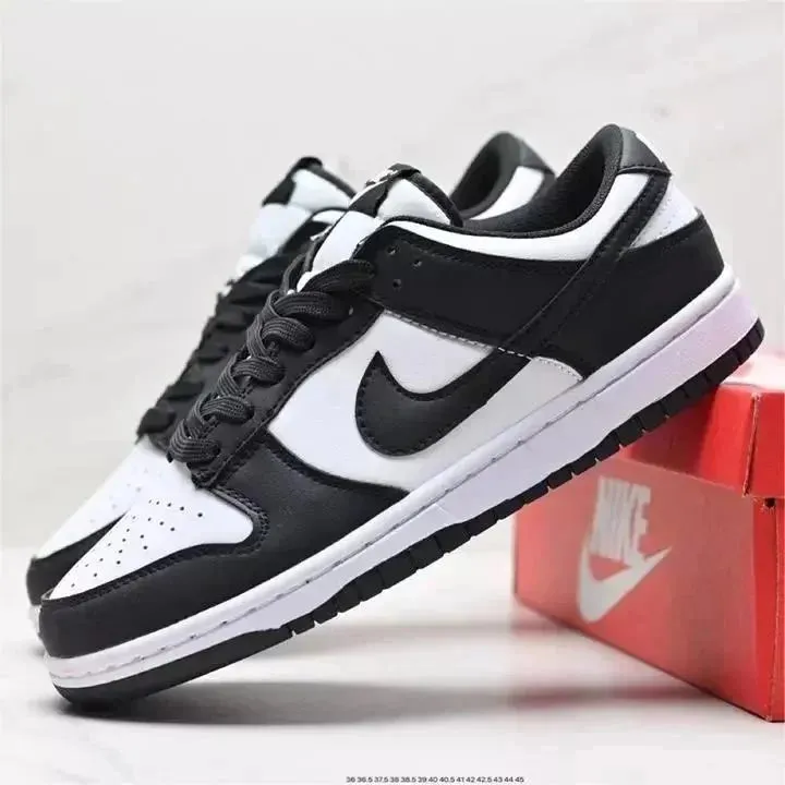 Nike black and white low-top sneakers with a large swoosh and perforated toe box.