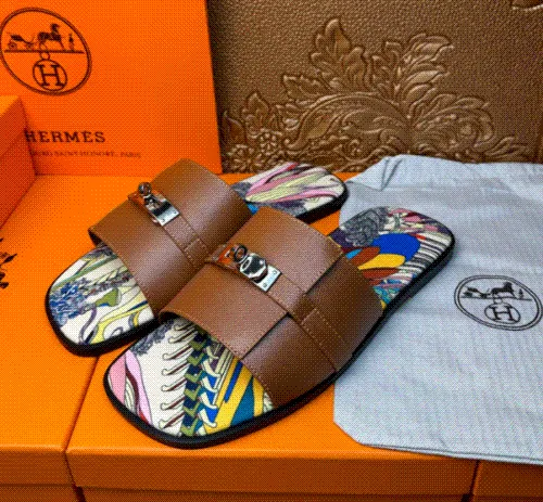 Hermes unisex casual slides with broad black crossover straps and a multicolor printed footbed.