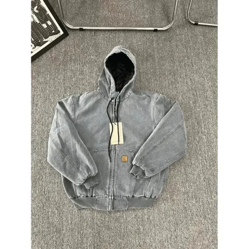 Carhartt hooded zip-up jacket in washed gray with a tan chest patch and black drawstrings.