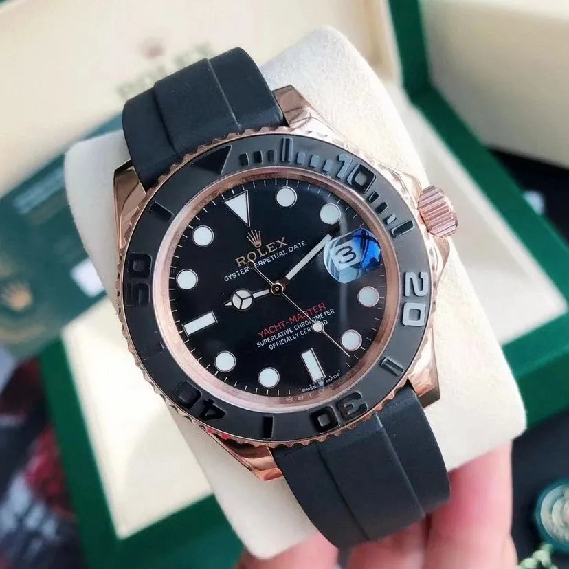 Rolex Yacht-Master watch with rose gold-tone case, black strap, and bold bezel markings.
