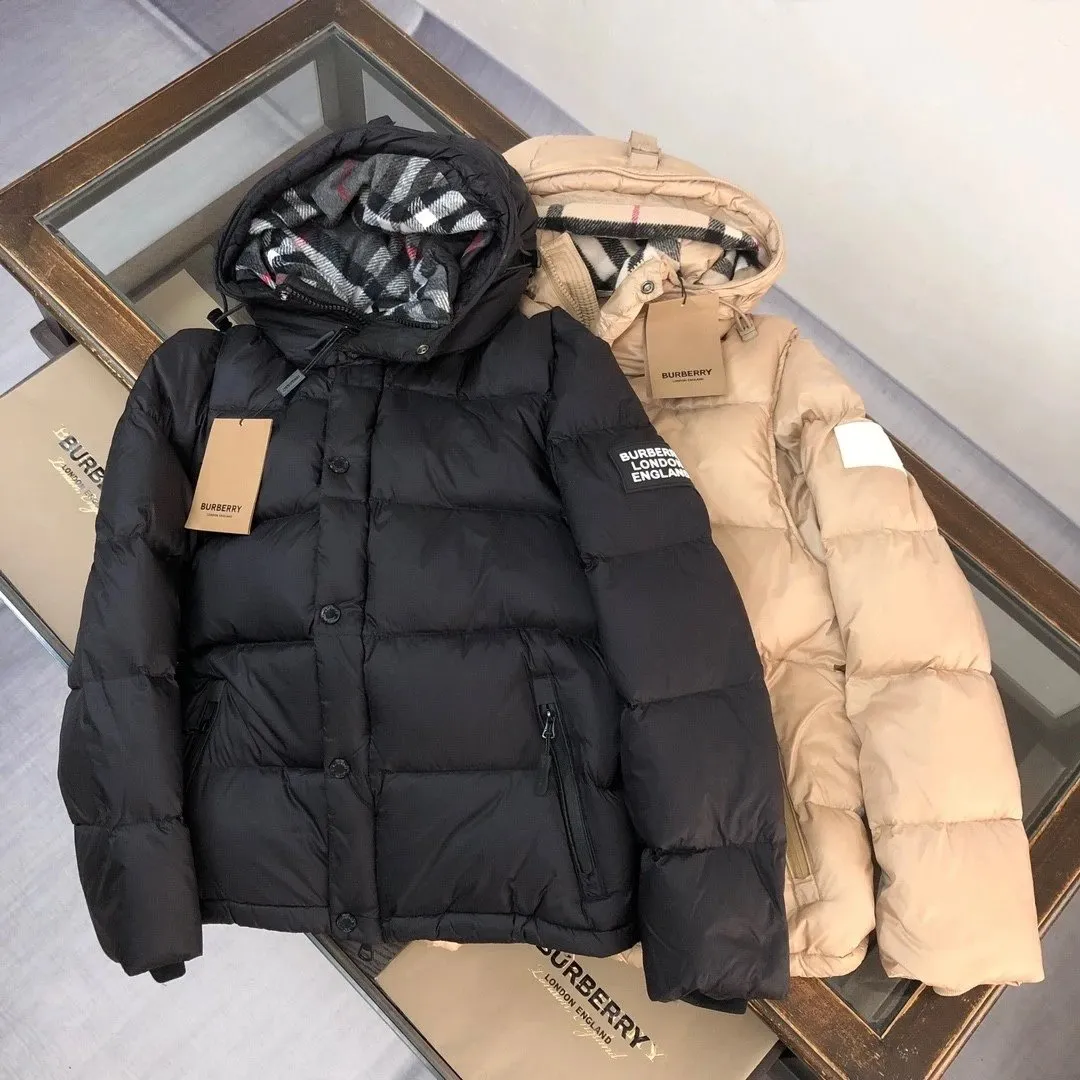 Burberry hooded puffer jacket with quilted baffles, chest patch, and zipper pockets.