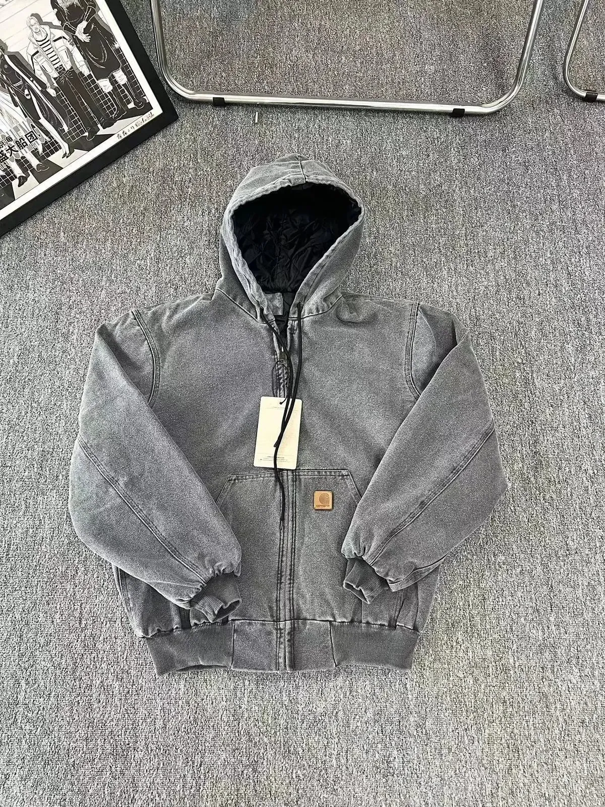 Gray Carhartt hooded zip-up jacket with a washed look and chest patch.