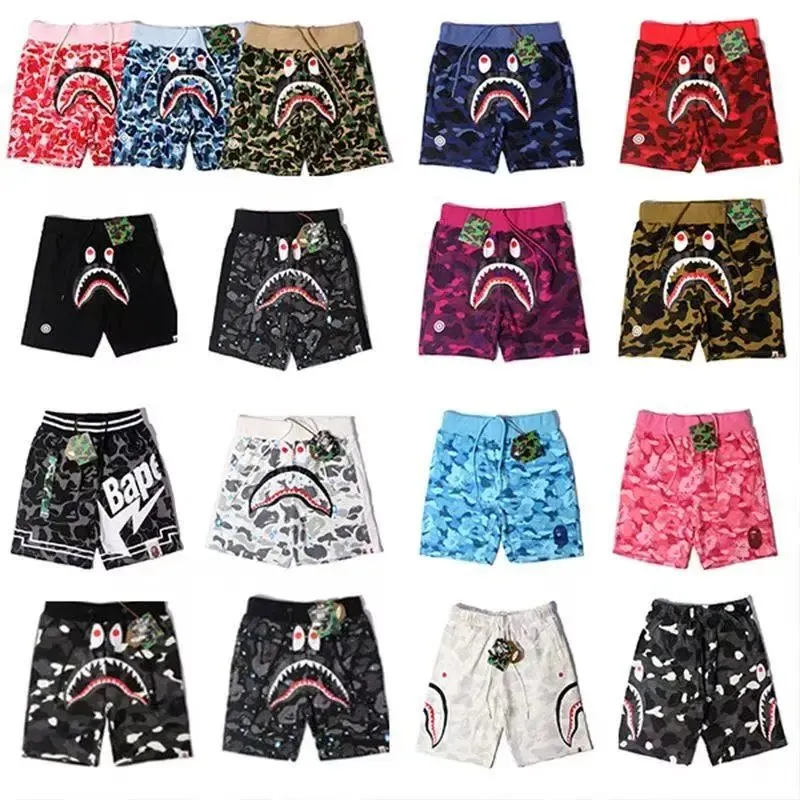 BAPE printed shorts with shark camo graphics and a loose knee-length fit.