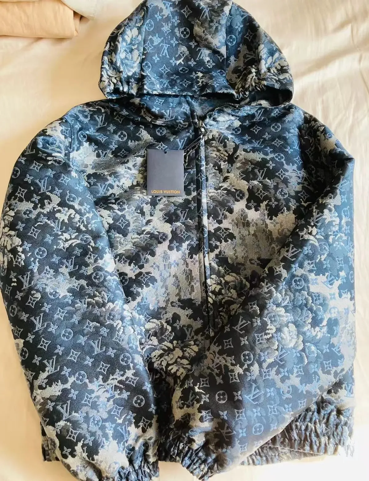 Louis Vuitton hooded puffer jacket with all-over monogram pattern and relaxed fit.