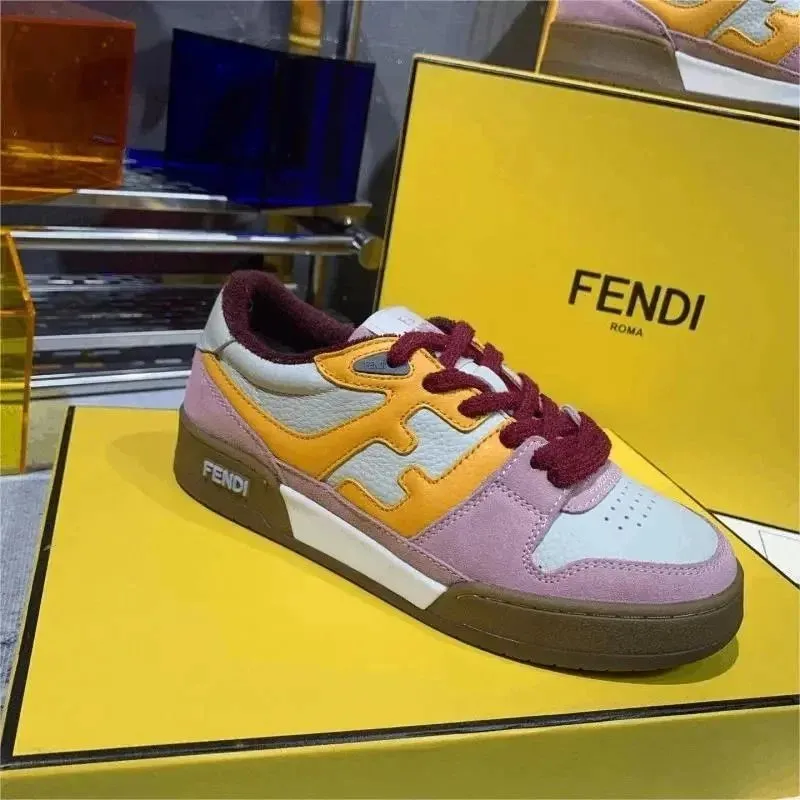Fendi low-top sneakers in yellow, lavender, and burgundy on a box.