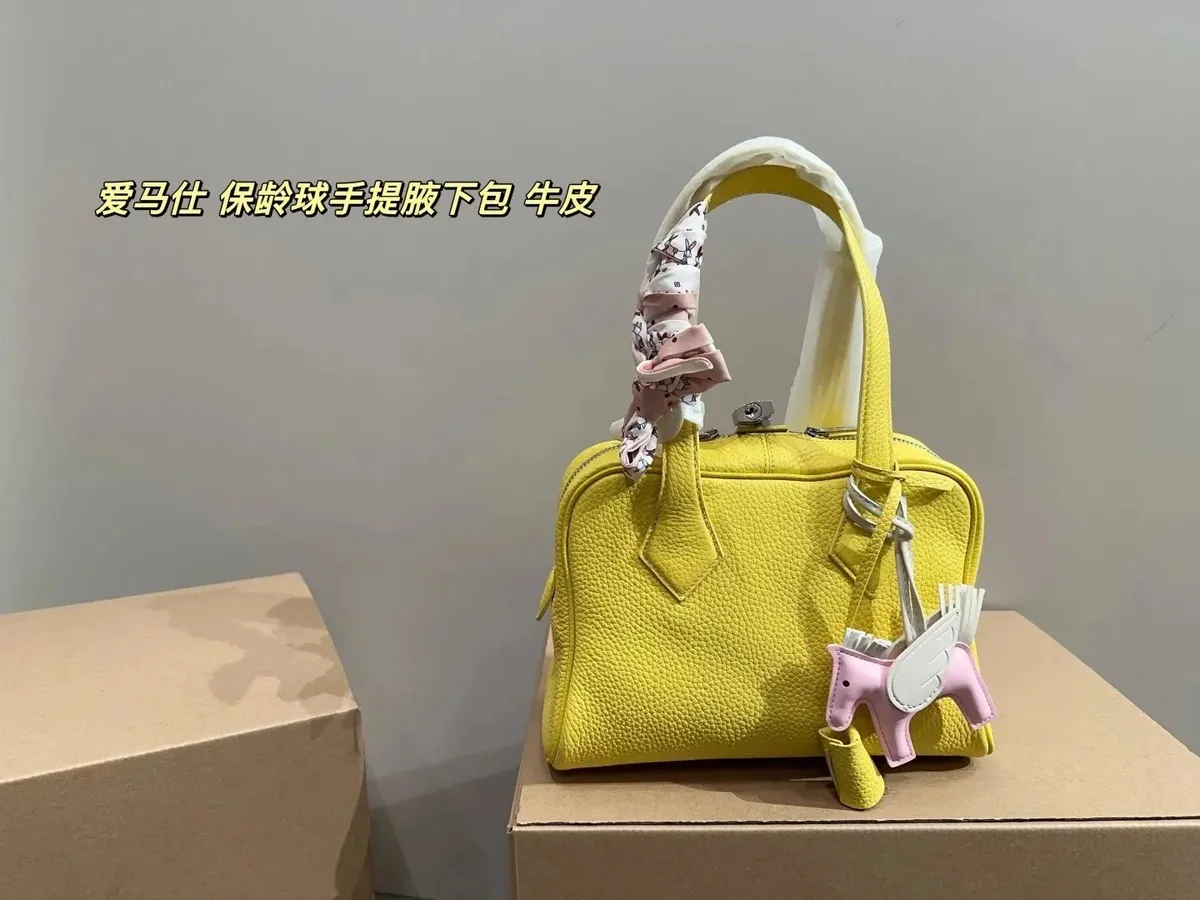 Gucci Curated Bag in a structured top-handle shape with charms and a scarf detail.