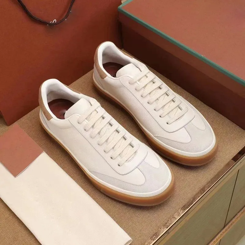 Unbranded low-top sneakers with a matte finish and gum-colored outsole.