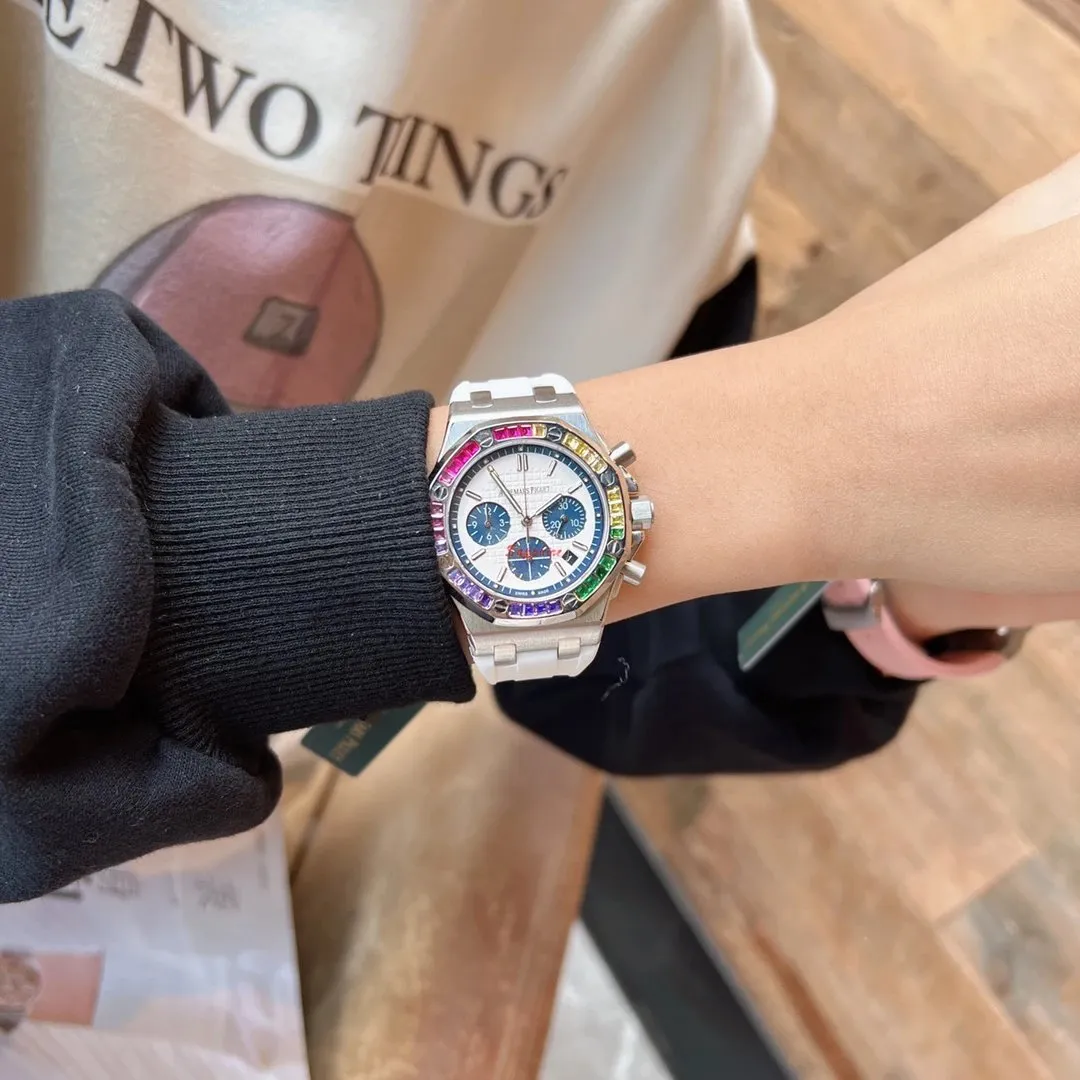 Audemars Piguet watch with a rainbow bezel, silver bracelet, and three subdials.