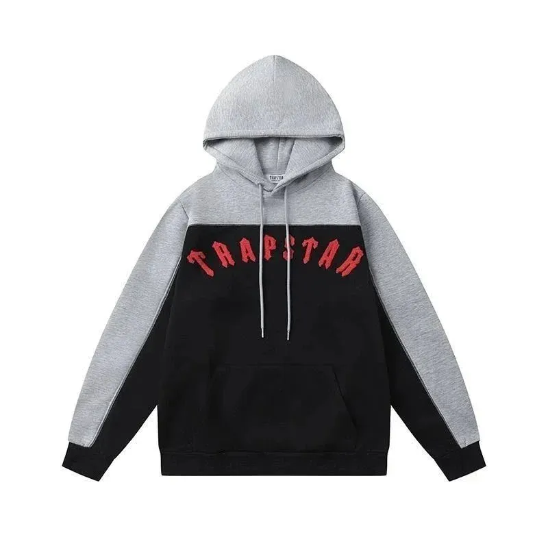 Trapstar colorblock pullover hoodie in black and gray with red chest text and a kangaroo pocket.