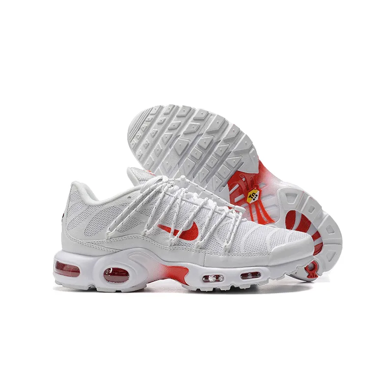 Nike athletic sneakers in white, light gray, and red with a chunky cushioned sole.