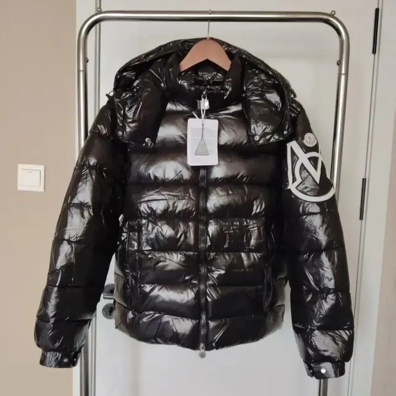 Black Moncler puffer jacket with hood, glossy shell, and sleeve logo patches.
