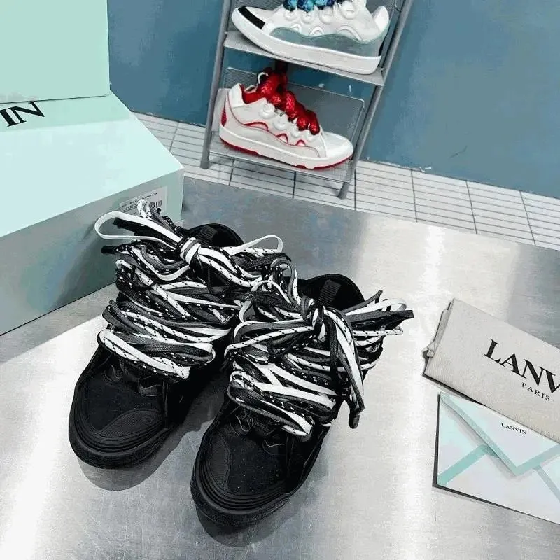 Lanvin black-and-white high-top sneakers with chunky soles and thick laces on display.