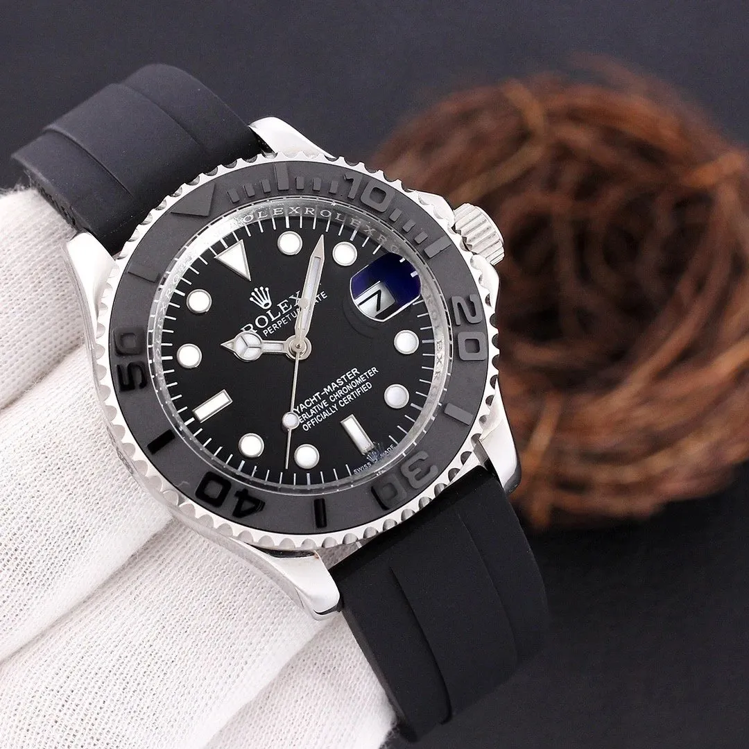 Rolex Yacht-Master watch with black dial, silver bezel, and black rubber strap.