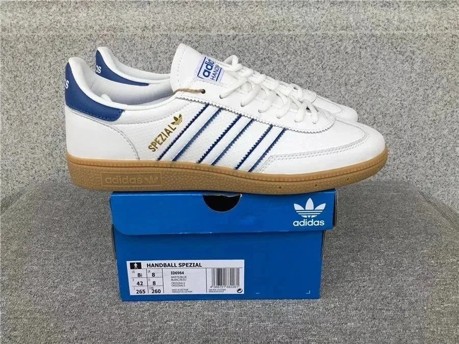 White Adidas sneaker with blue stripes, gum sole, and Spezial branding on a shoebox.