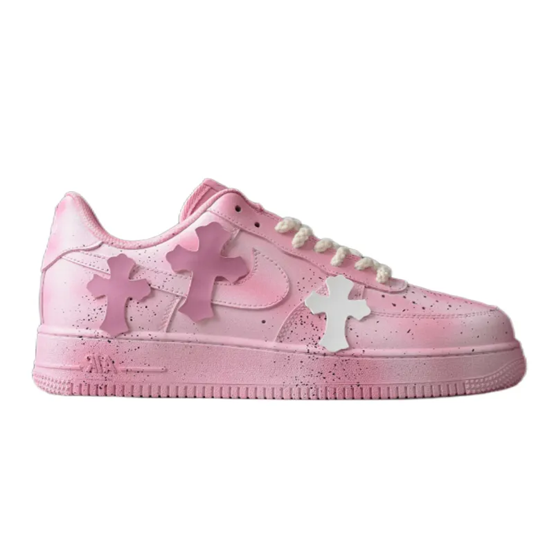 Nike low-top pink sneakers with a white sole and side appliques on a studio background.
